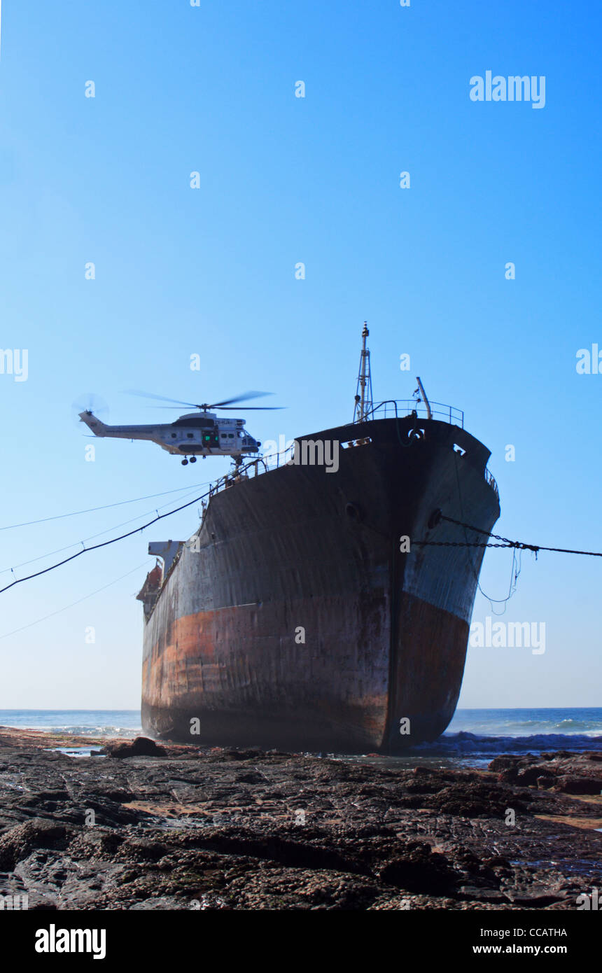 A helicopter hovers over the MT Phoenix which ran aground at Sheffield Beach on the Kwazulu Natal North Coast, South Africa Stock Photo