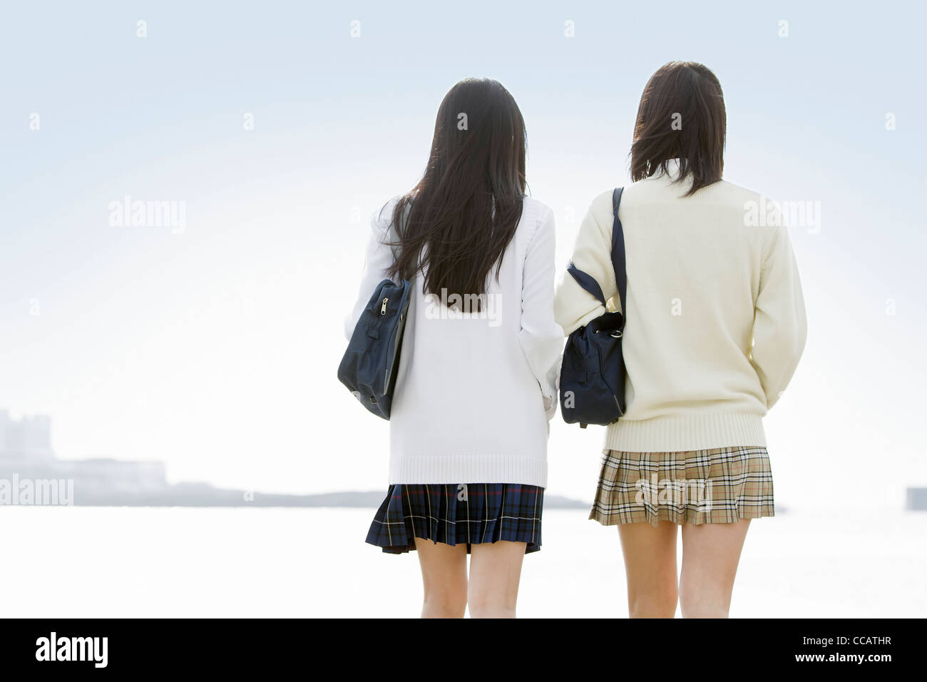 Two high school girls looking at the ocean Stock Photo