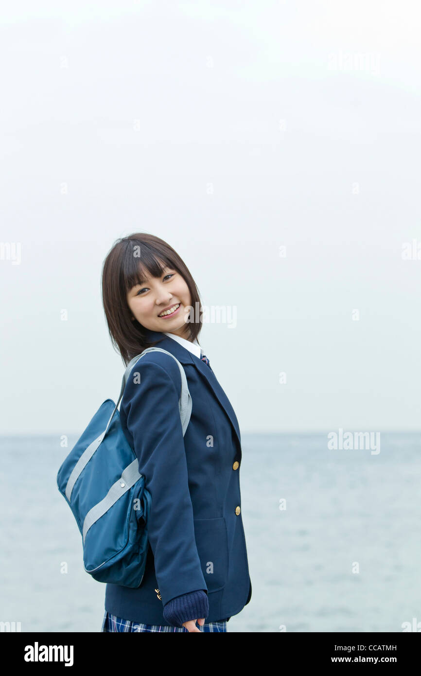 High school girl by the ocean Stock Photo