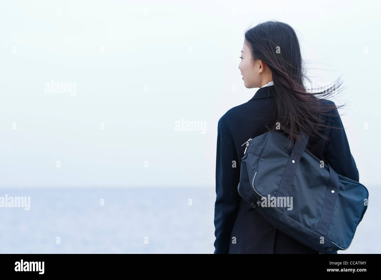 High school girl looking at the ocean Stock Photo