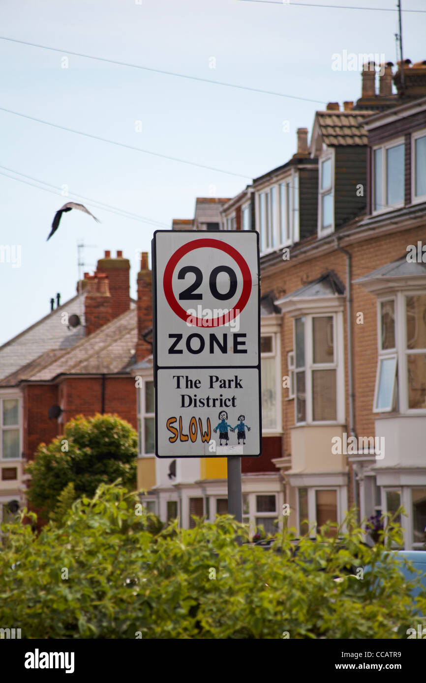 Slow 20 zone sign in the Park District, Weymouth, Dorset UK in July - 20 speed limit sign traffic road sign Stock Photo