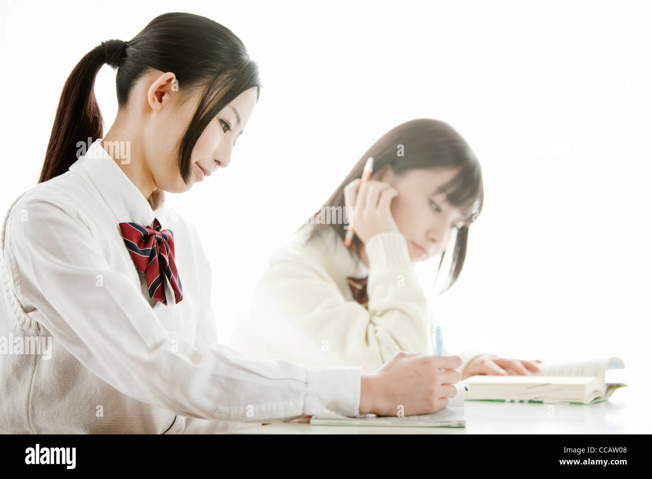 Two high school girls in class Stock Photo - Alamy