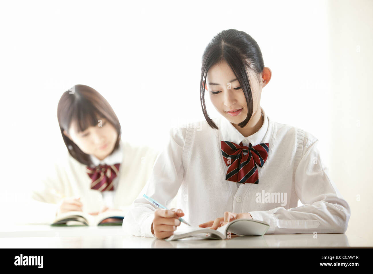 Two high school girls in class Stock Photo