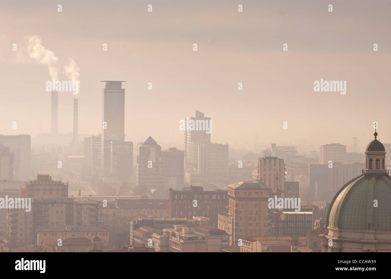 Skyline of a city with smokestaks and smog Stock Photo