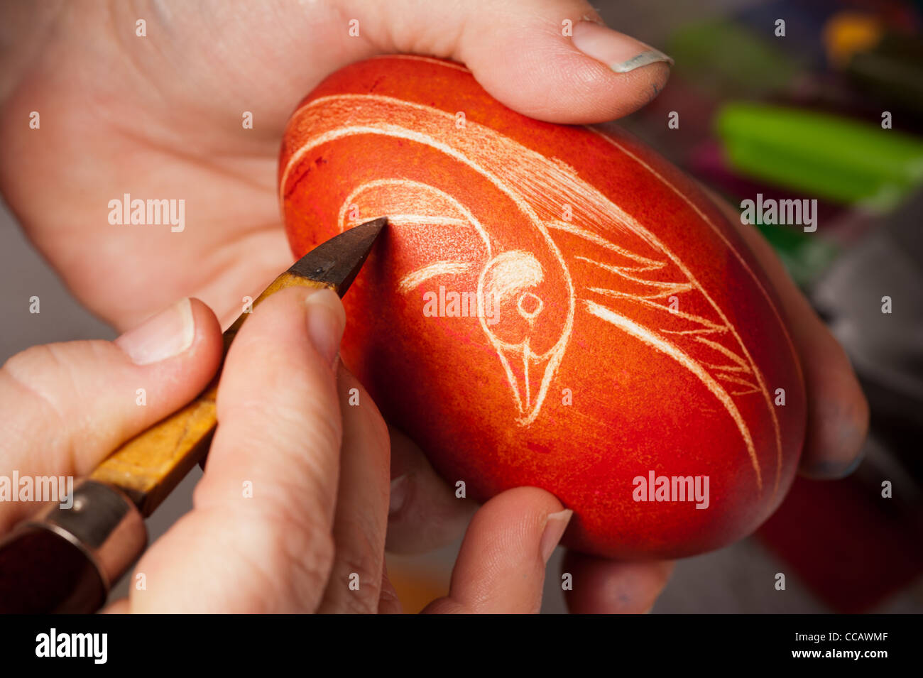 Hands etching a egg in Polish tradition of Pisanki Stock Photo