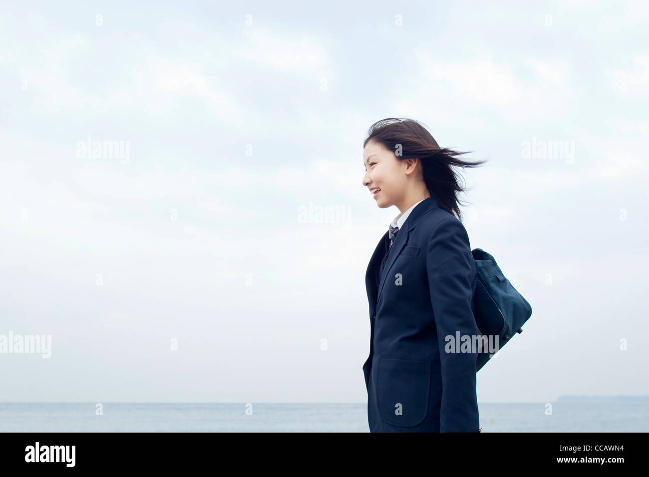 High School Student Standing by Sea Stock Photo
