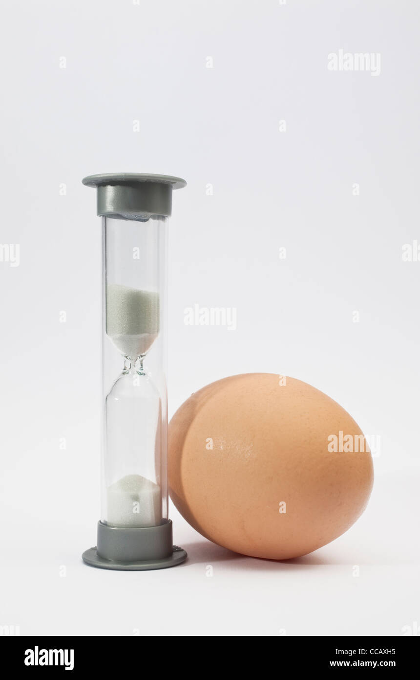 A small egg timer or hourglass, used for timing the boiling of an egg