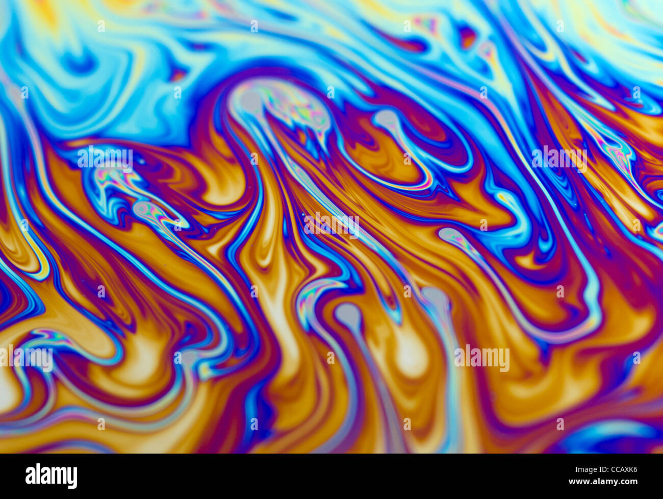 Macro close up of the surface of a colourful soap bubble with shallow focus. Stock Photo