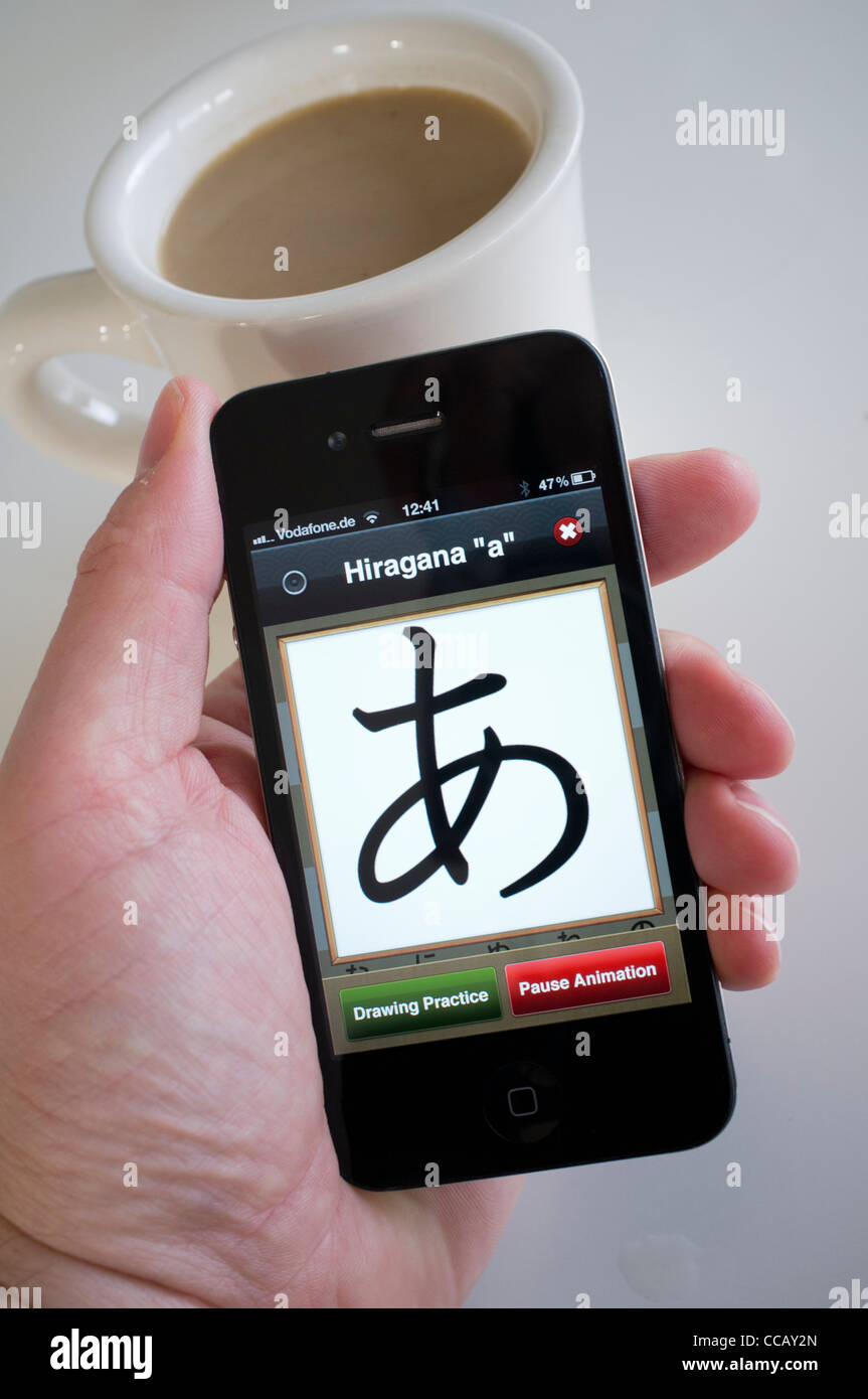 Student learning to write Japanese using educational application on an ...