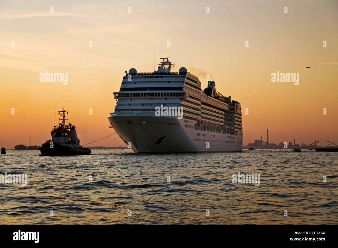 Cruise liner ship MSC Musica leaves Venice under tow from tugboat Stock Photo