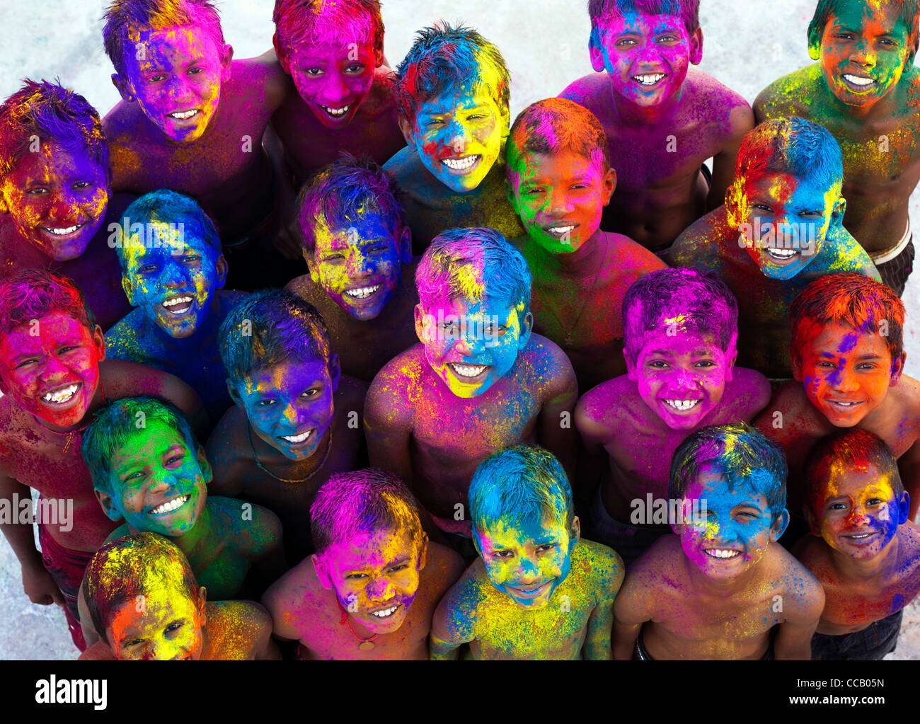 Young Happy smiling Indian boys covered in coloured powder pigment. India Stock Photo