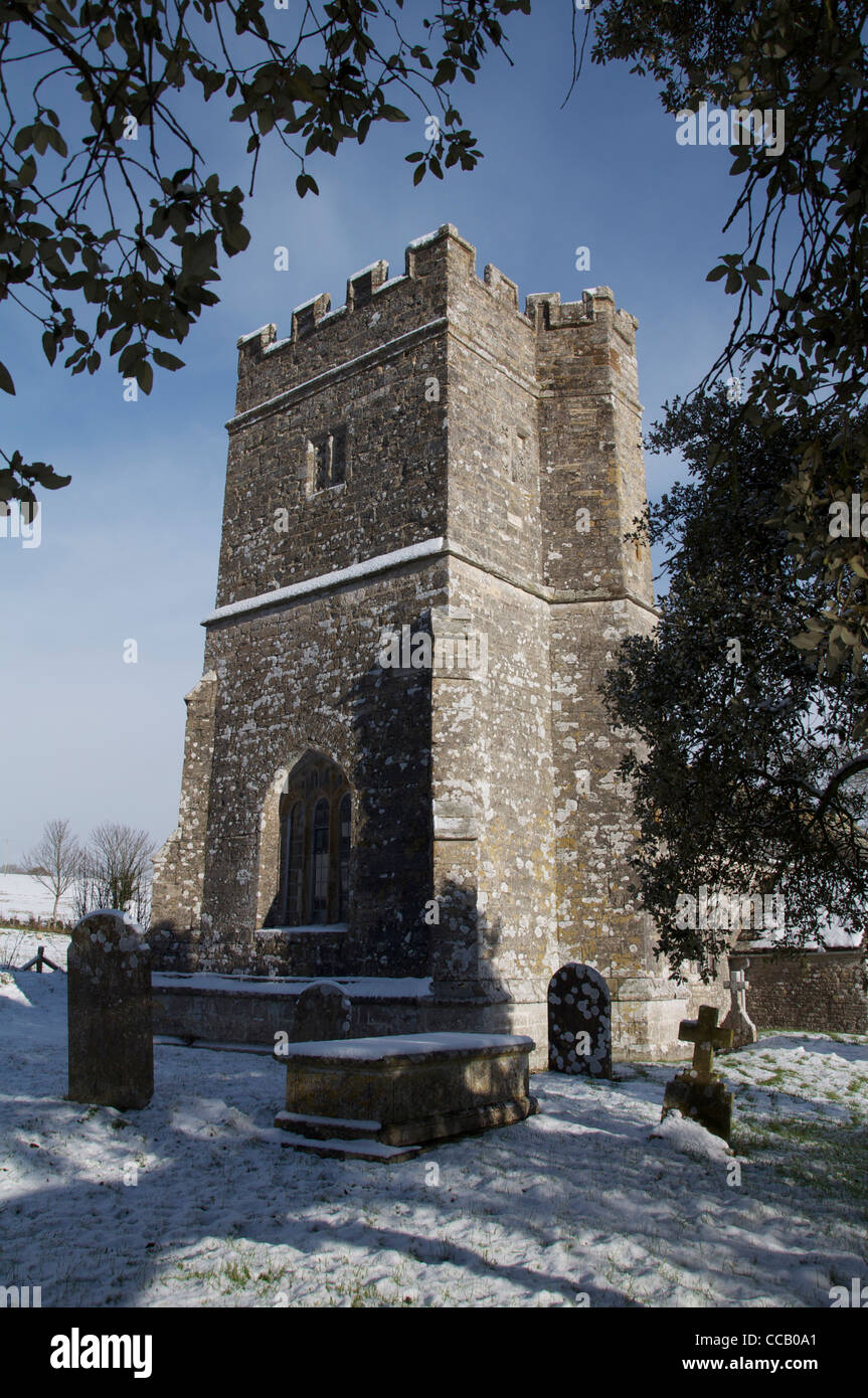 The tower of the historic 12th century church at Whitcombe, in the snow. The Dorset poet William Barnes was curate here from 1847 to 1852. England, UK Stock Photo