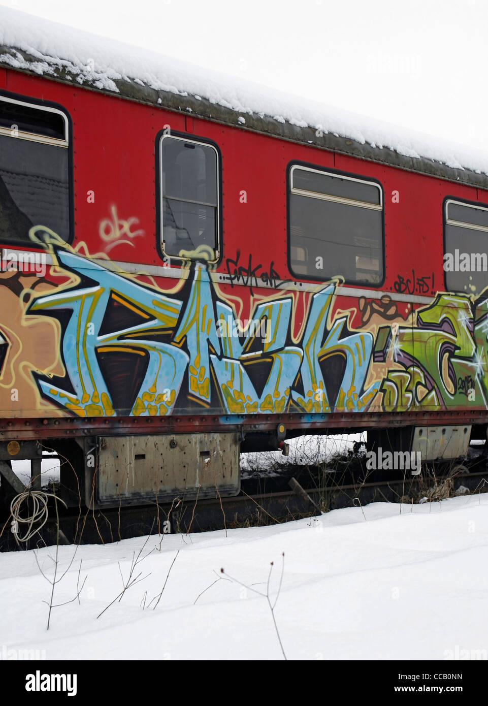 outdoor shot of a old tagged railway car in Southern Germany at winter time Stock Photo