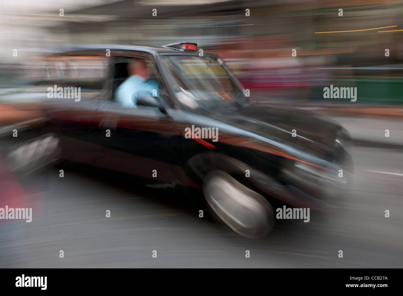 Panned image of a speeding London taxi, Covent Garden,  London, England Stock Photo