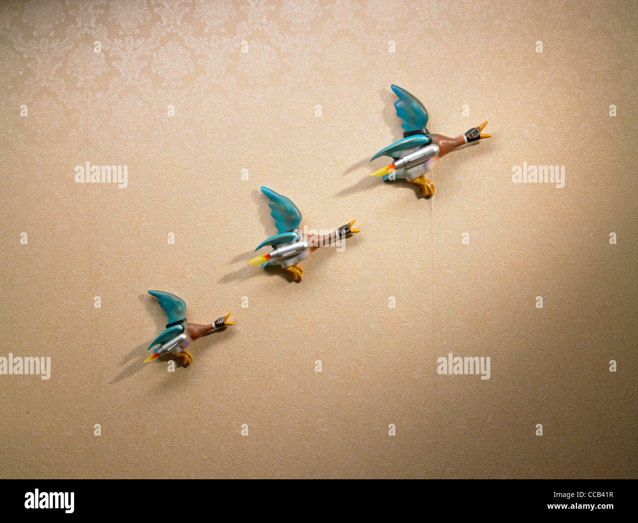 a line of rocket powered ducks on the wall Stock Photo
