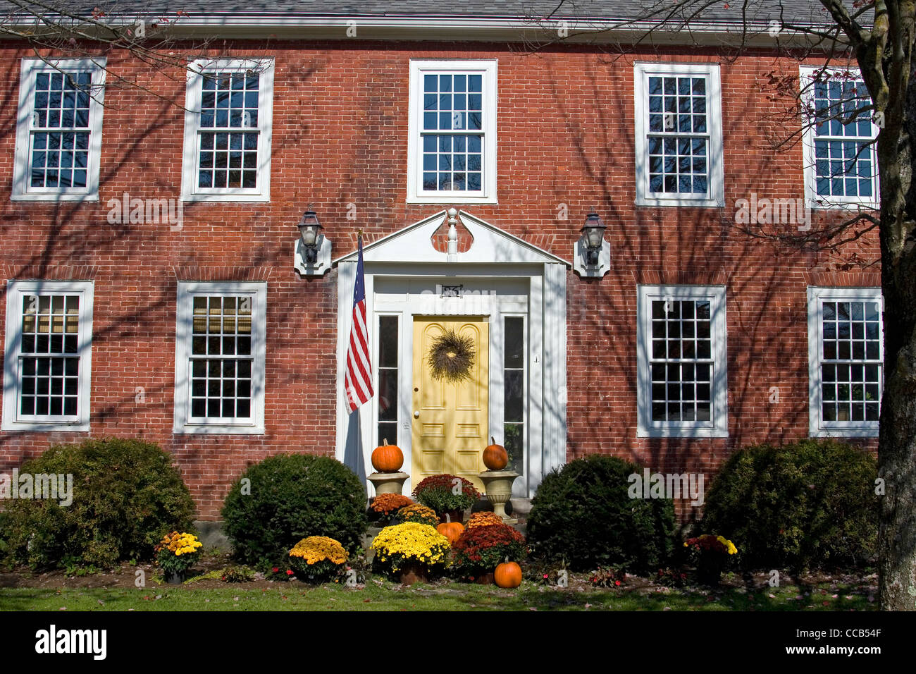 Cambridge Vermont red brick house decorated with fall foliage Stock