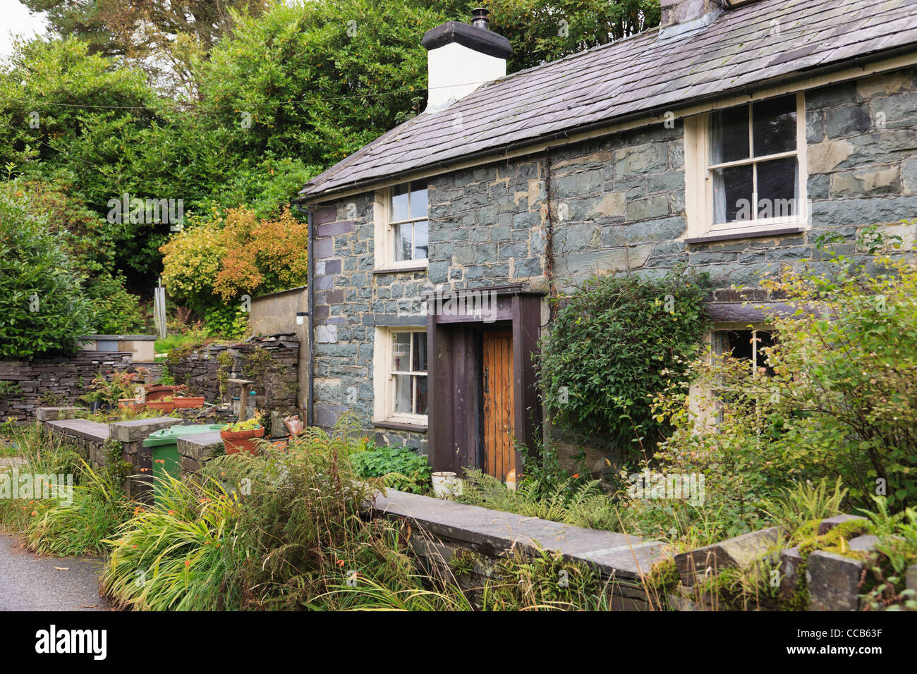 Old miner's stone cottage with traditional Welsh slate porch in
