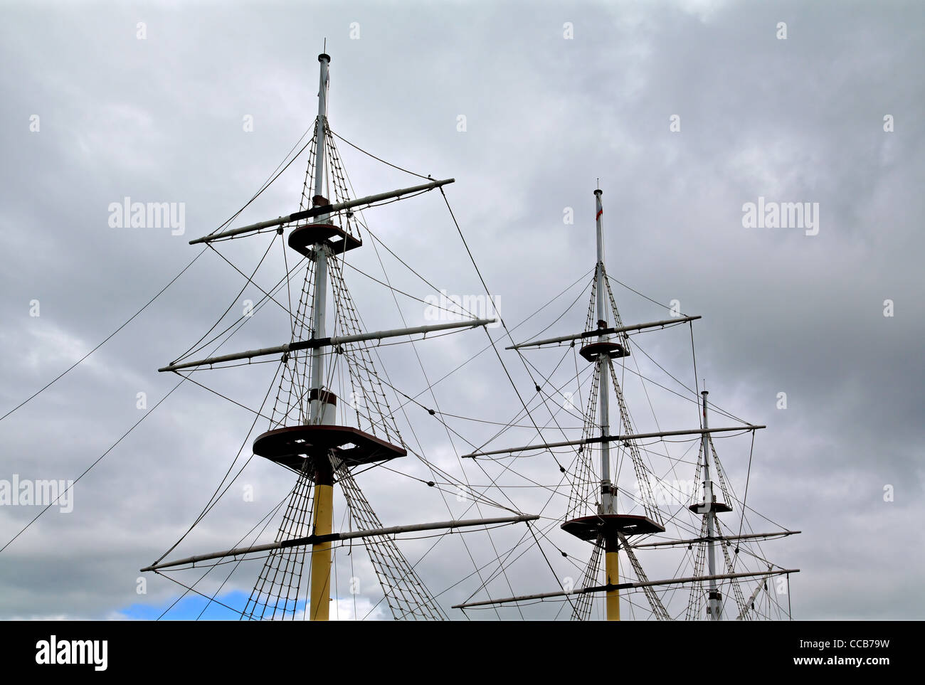 ship masts on cloudy sky Stock Photo