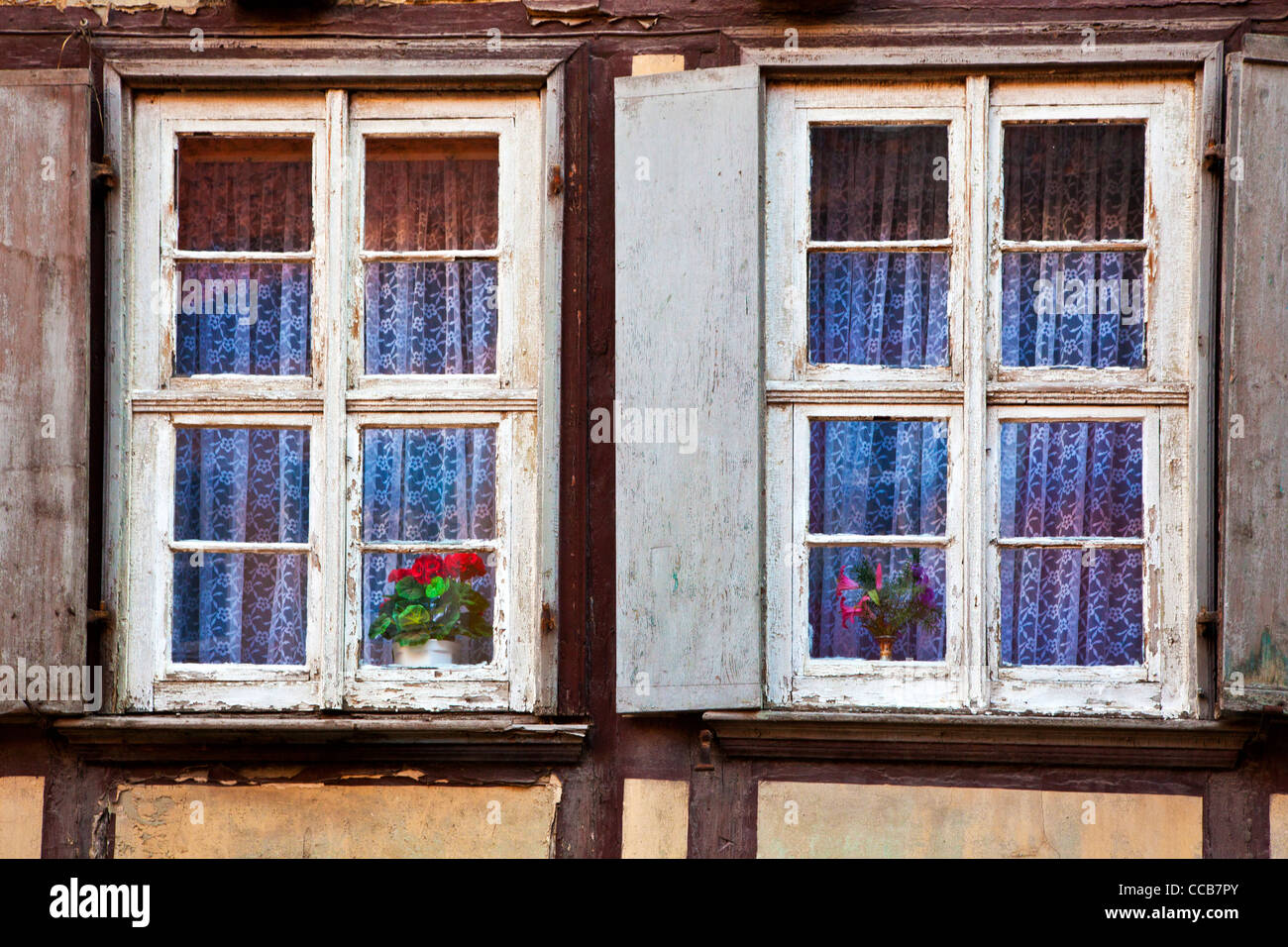 Two windows on a dilapidated house facade in the UNESCO German town of Quedlinburg in Saxony Anhalt, Germany Stock Photo