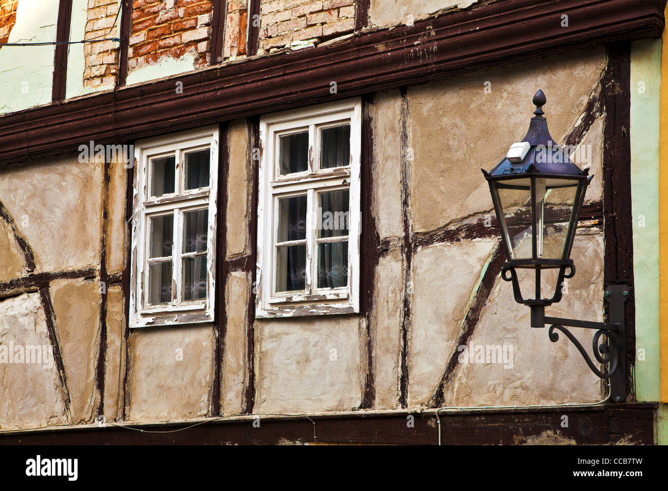 Old wooden windows on a dilapidated half-timbered house in the UNESCO German town of Quedlinburg in Saxony Anhalt, Germany Stock Photo