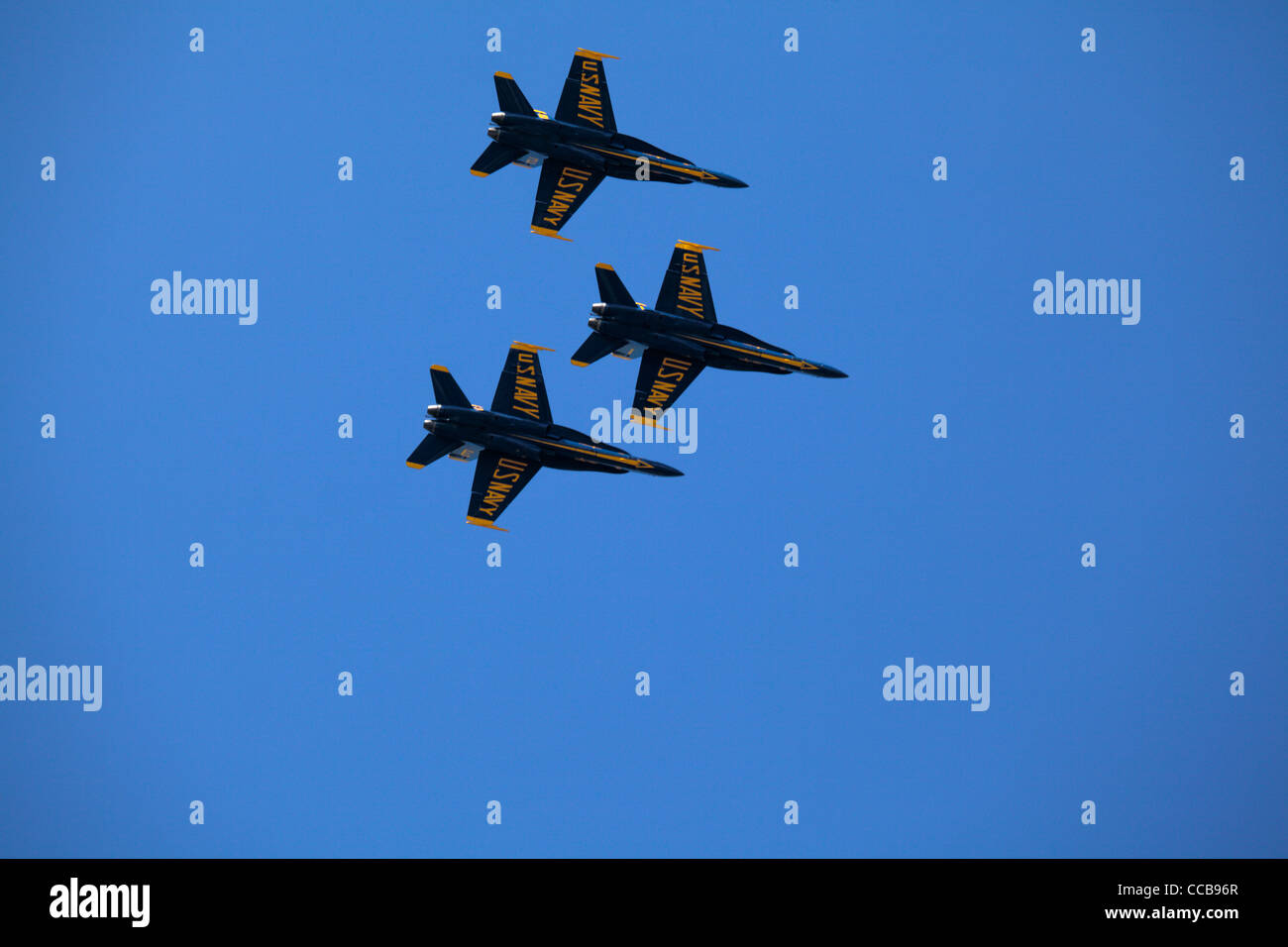 Three USAF Blue Angels fighter jets in tight formation in blue sky. Stock Photo