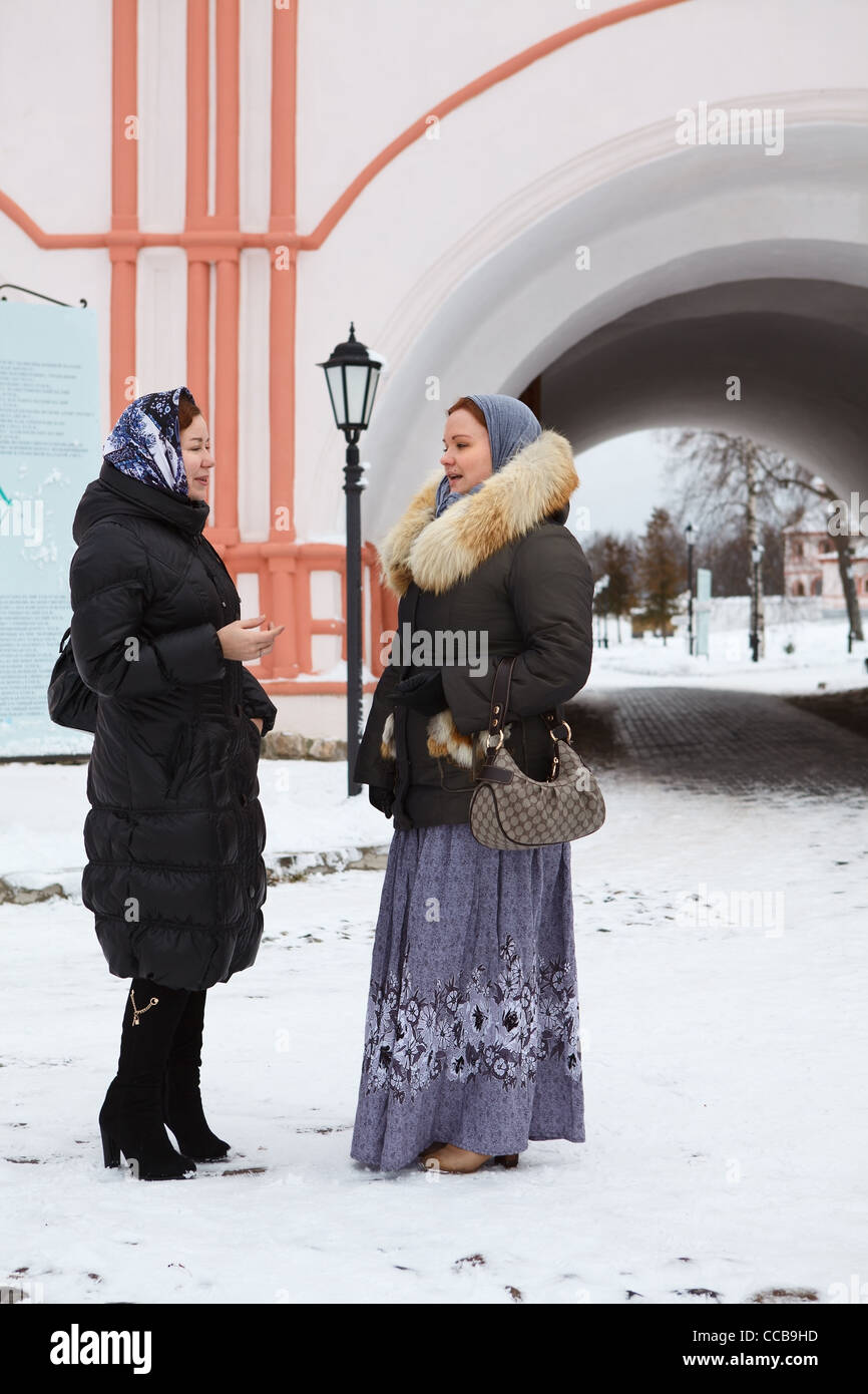 Two Russian women in winter clothes against Orthodox monastery building.  Pilgrimage in Russia Stock Photo - Alamy