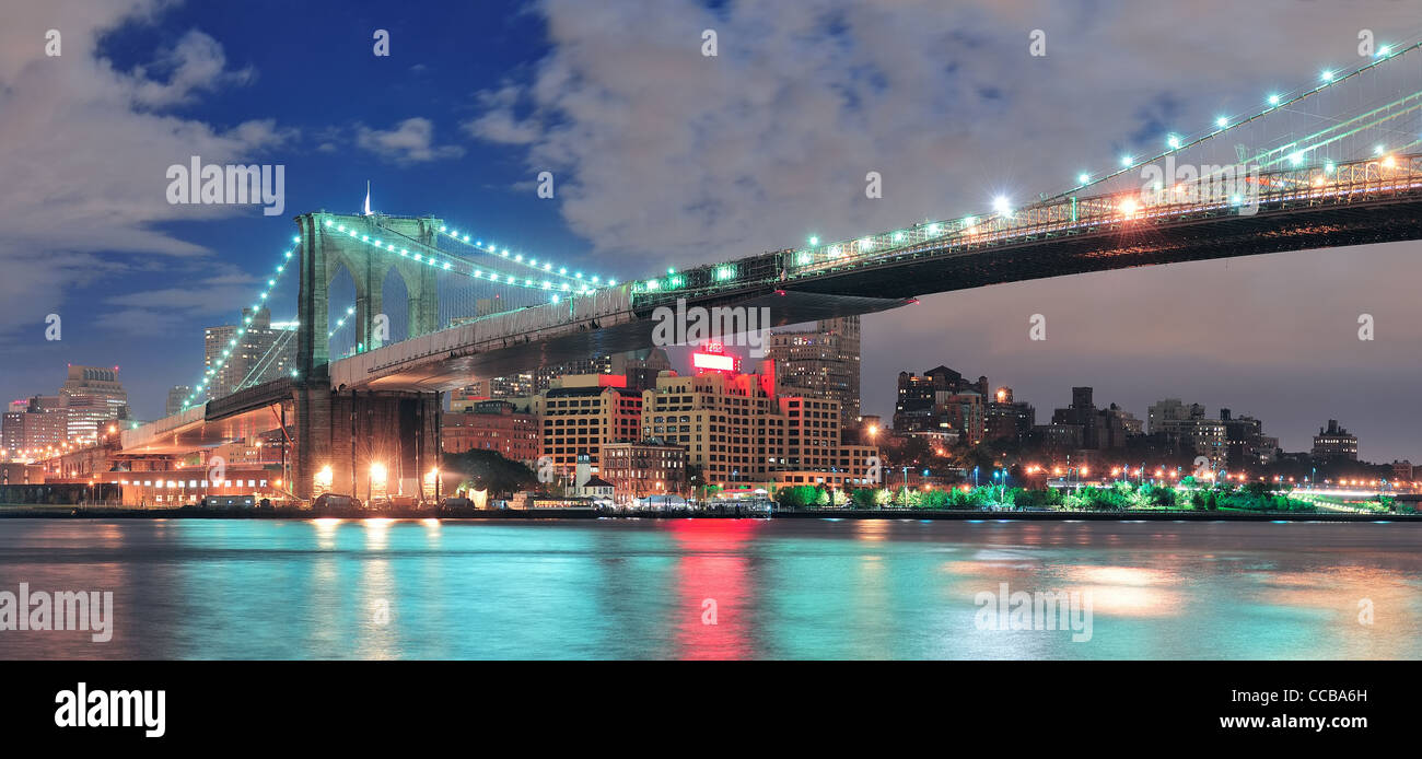 Brooklyn Bridge panorama over East River at night in New York City ...