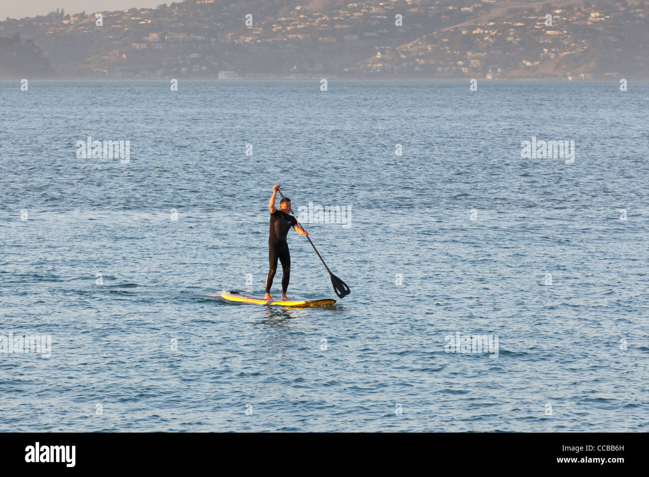 A man paddle boarding on water Stock Photo