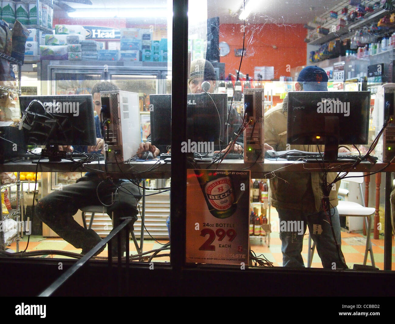Three men rent computer time in corner grocery store, Grand Street