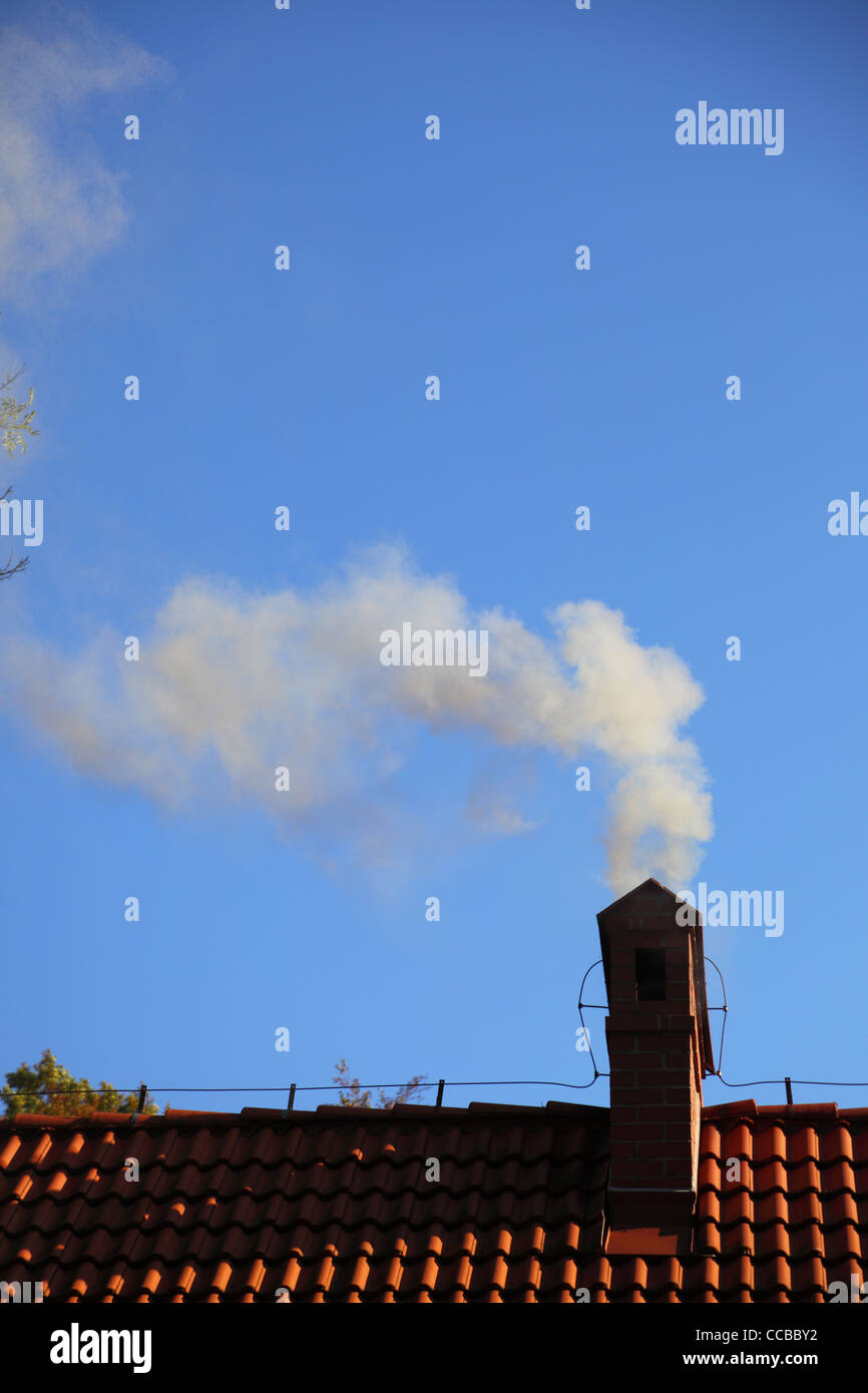 Smoke from a chimney sky blue nobody Stock Photo - Alamy