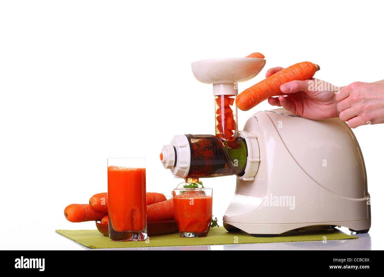 Juice extractor and carrot isolated white kitchen prepare Stock Photo