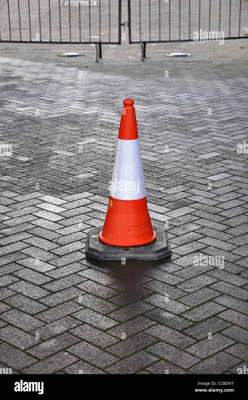 Single traffic cone in front of crowd barriers Stock Photo Alamy