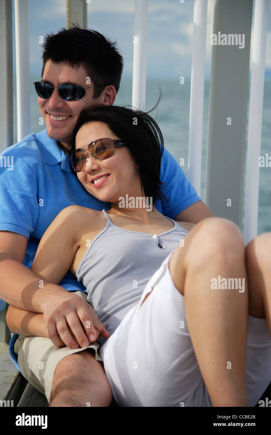young woman sitting in lap of man and smiling Stock Photo - Alamy