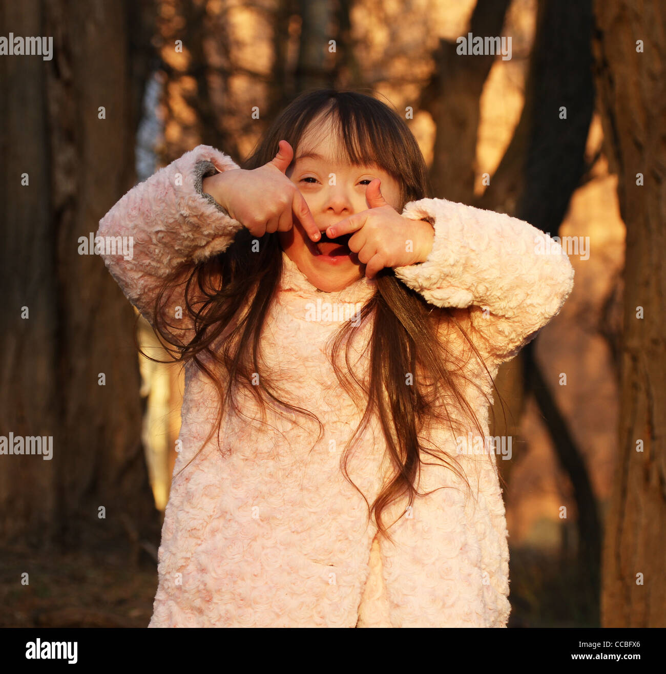 Portrait of beautiful happy girl giving thumbs up Stock Photo - Alamy
