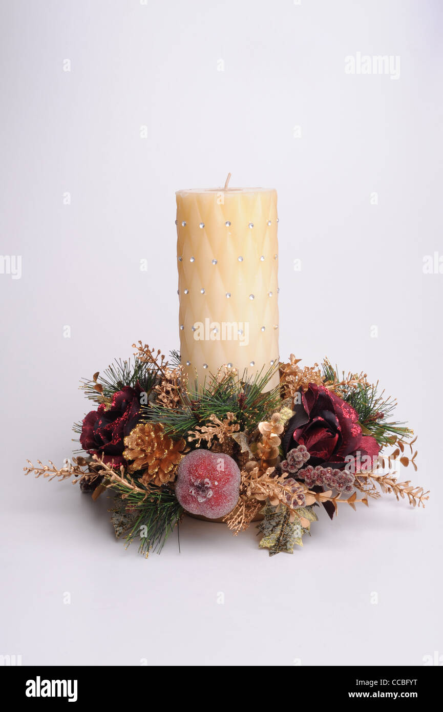 Photograph of a candle with festive decoration around base Stock Photo