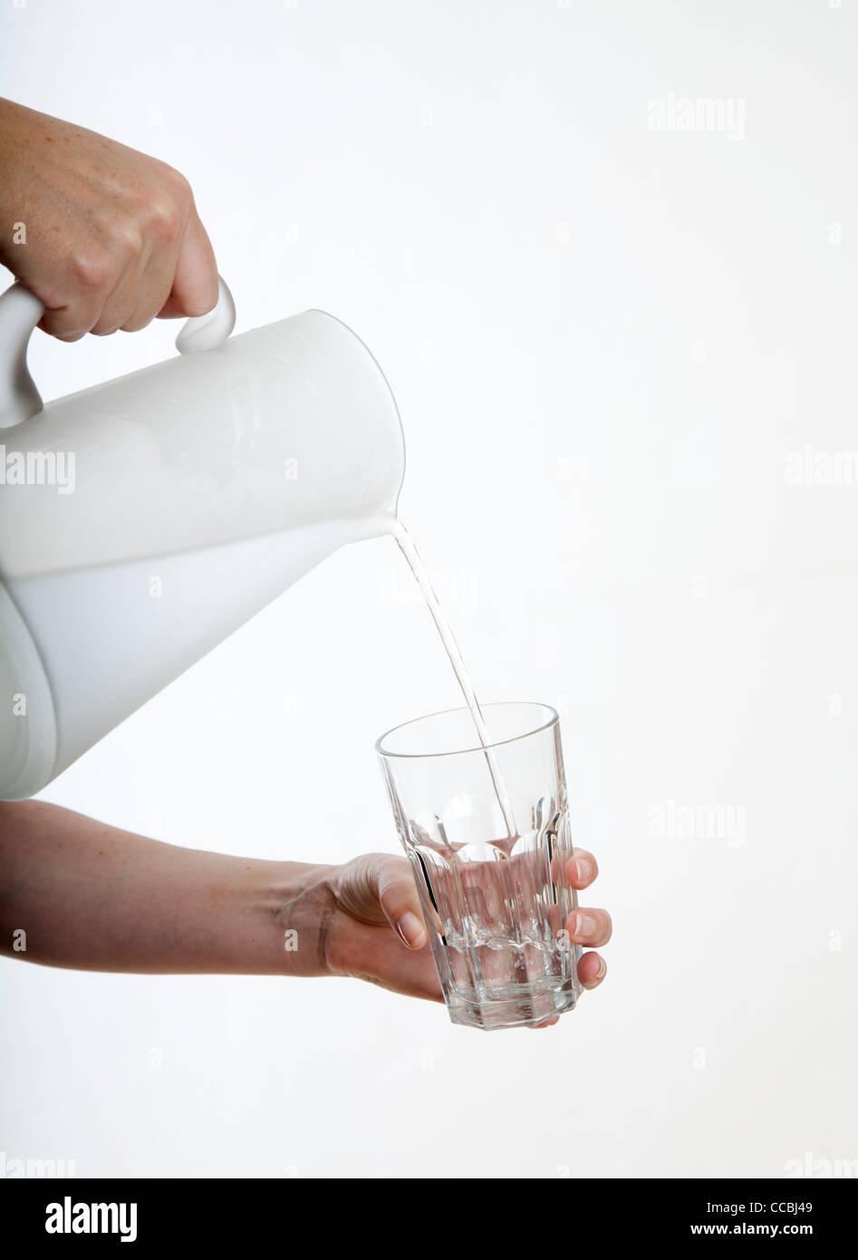 Woman pouring liquid into glass Stock Photo Alamy