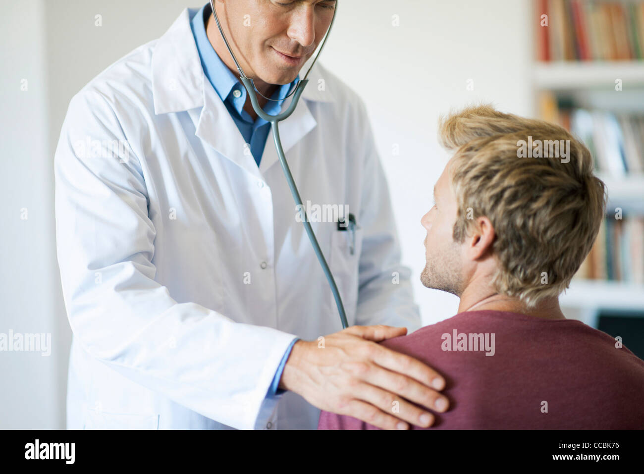 Doctor using stethoscope on patient Stock Photo Alamy