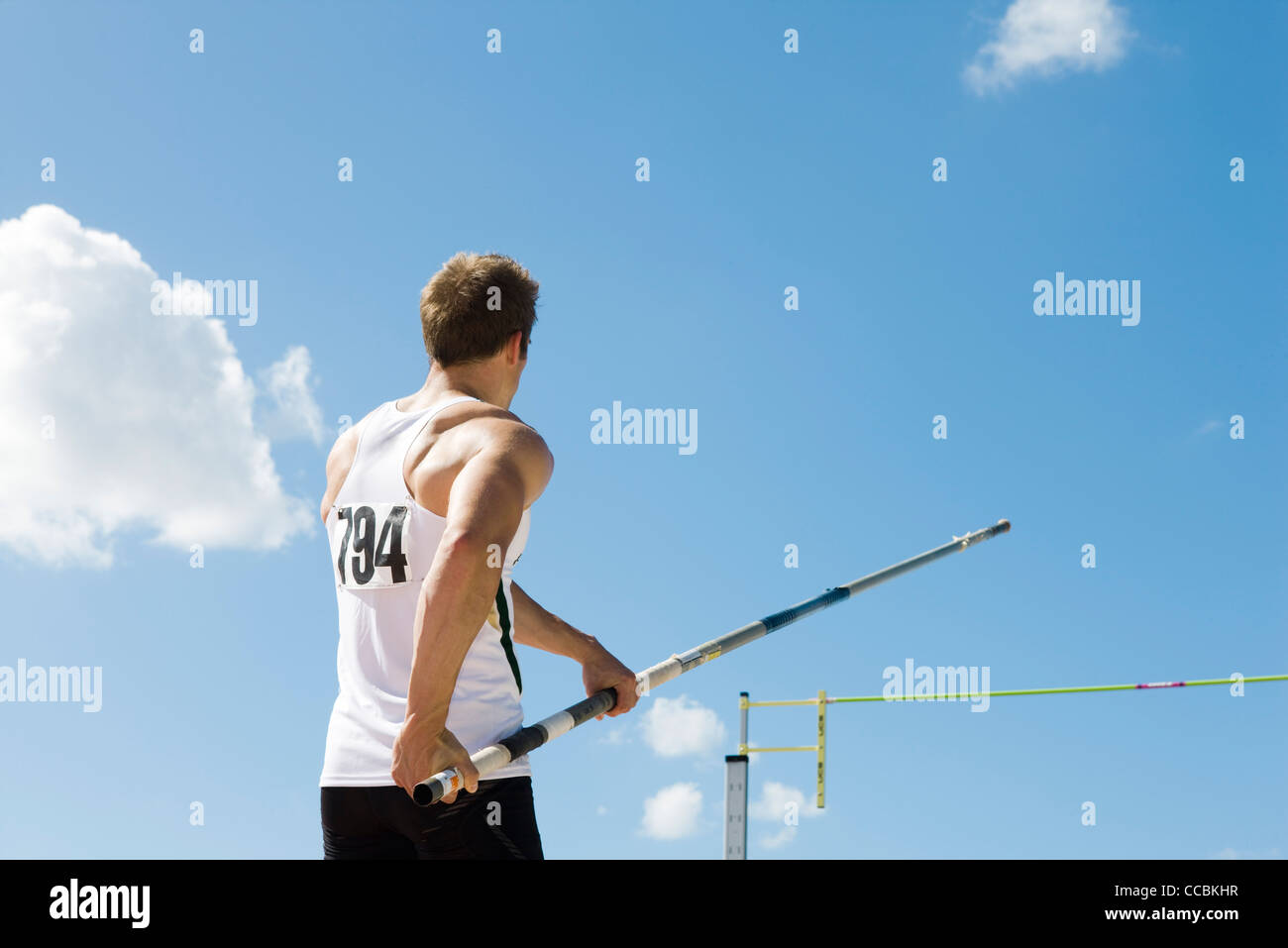 Athlete in pole vaulting competition, rear view Stock Photo Alamy