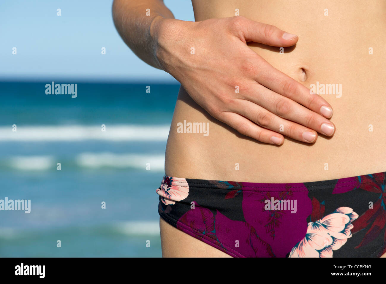 Closeup picture of female belly, bikini Stock Photo by