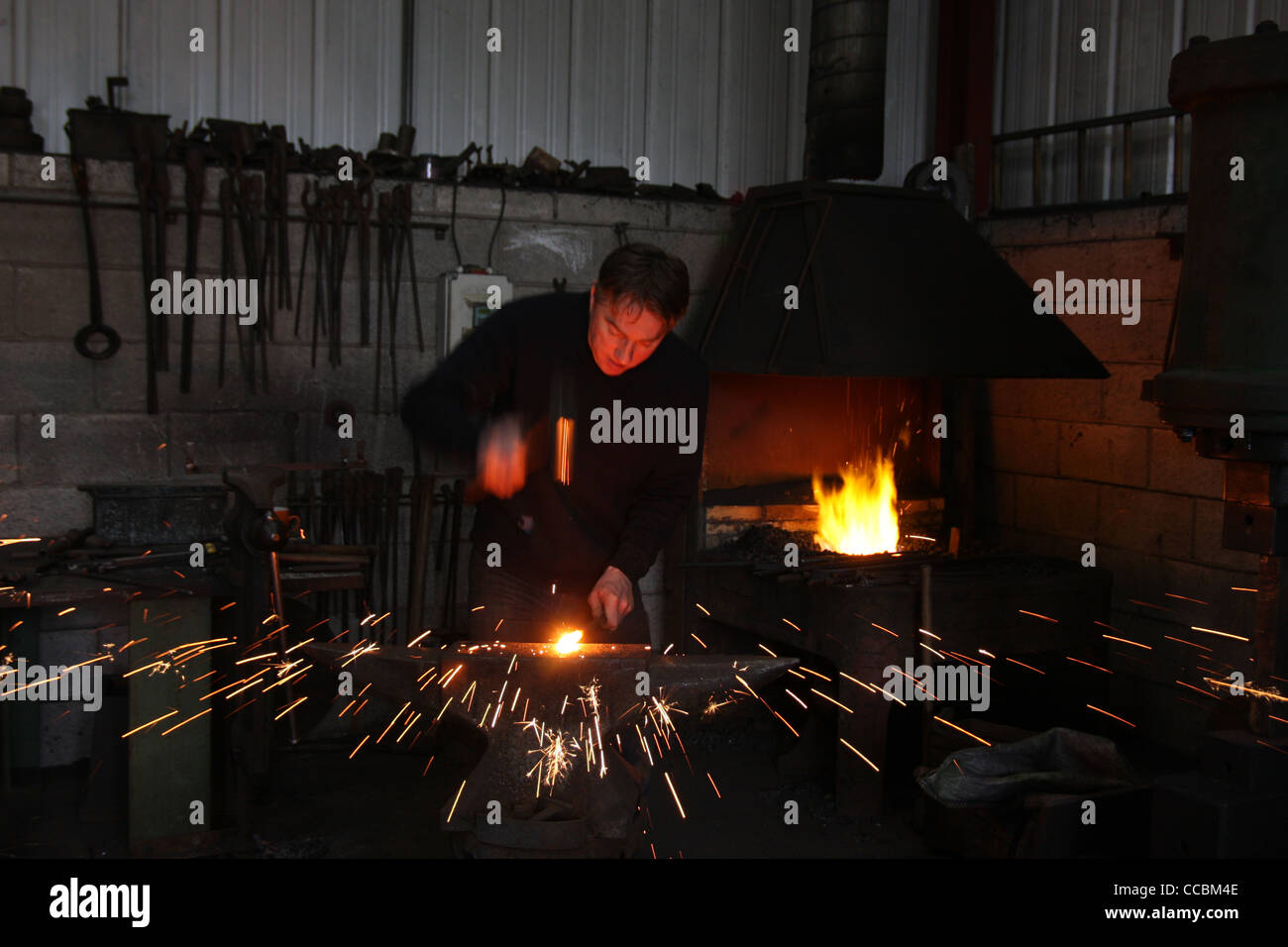 Metal being shaped at a forge Stock Photo - Alamy