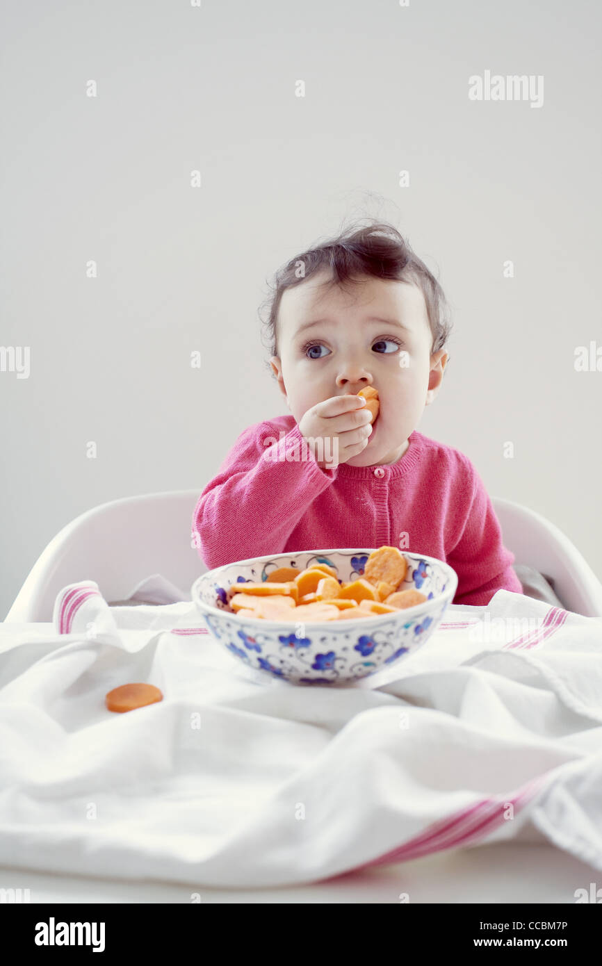 Infant eating carrots, portrait Stock Photo Alamy