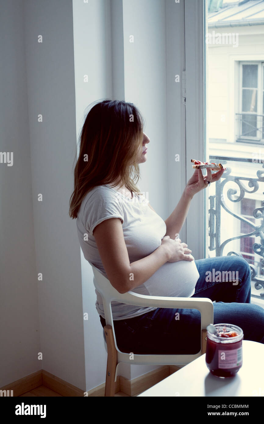 Pregnant woman eating toast with jam Stock Photo Alamy