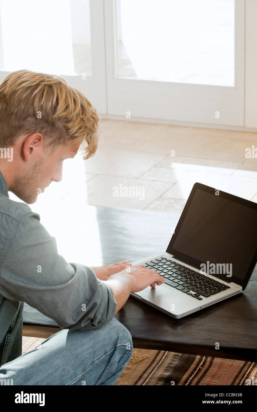 Man using laptop computer at home Stock Photo - Alamy