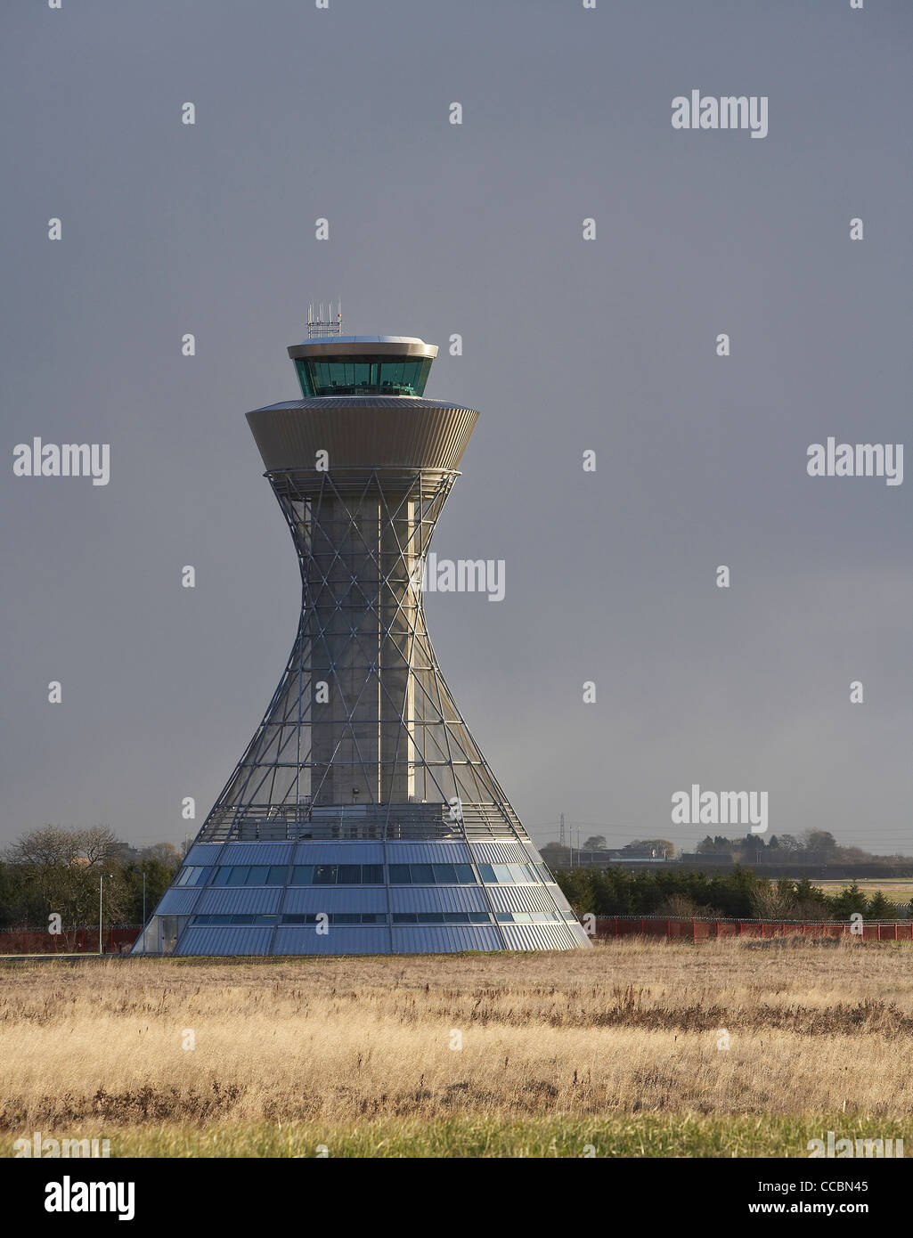 NEWCASTLE AIRPORT CONTROL TOWER LONG SHOT WITH YELLOW GRASS AND SLATE SKY Stock Photo