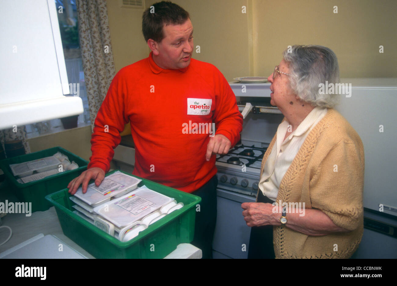 Elderly lady receiving delivery of frozen meals for meals on wheels
