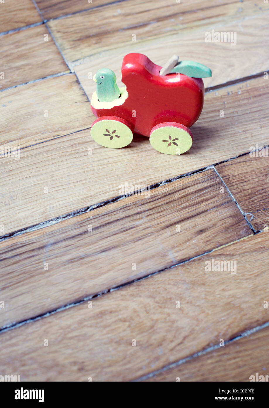 Toy car on hardwood floor Stock Photo