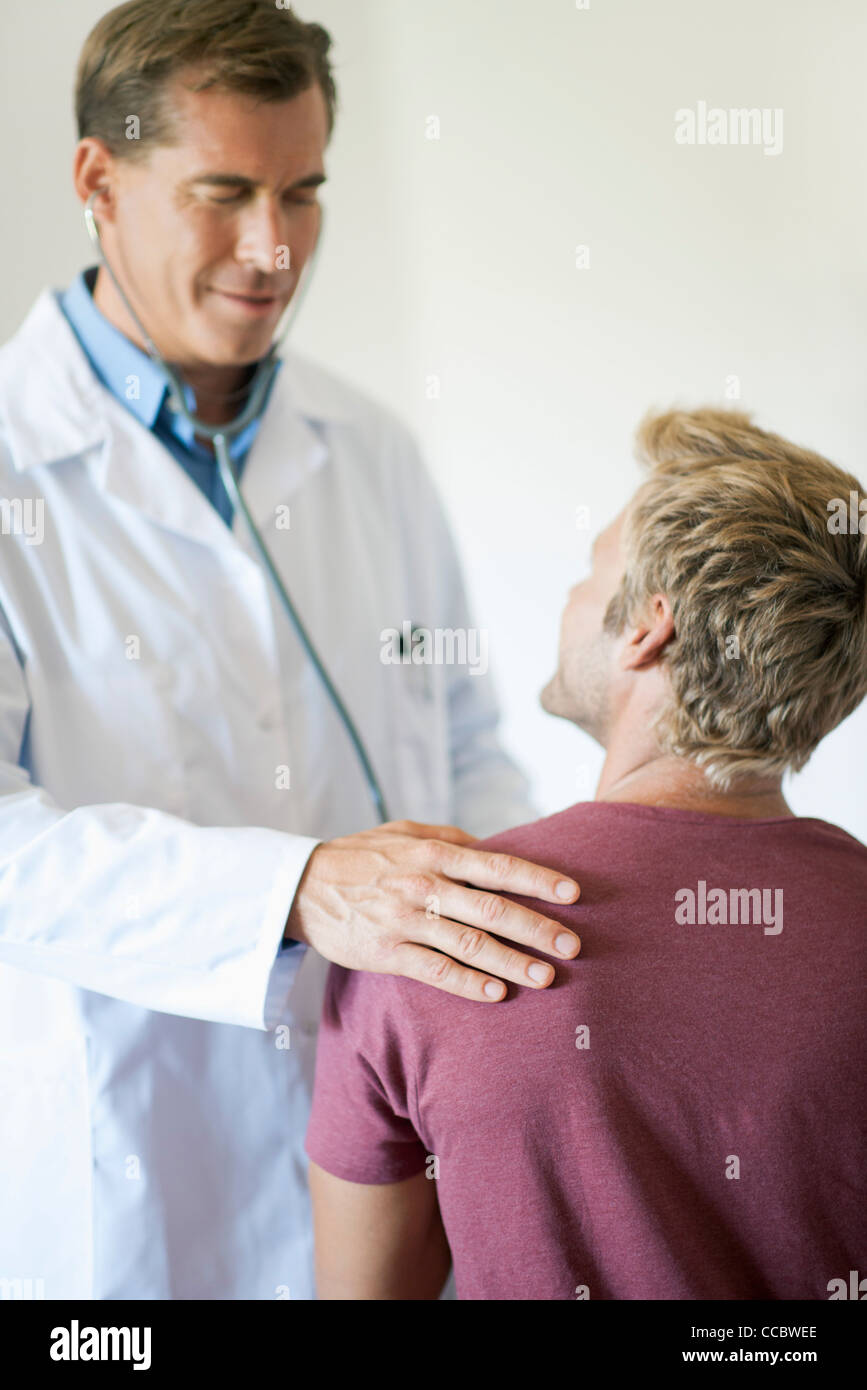 Doctor talking with patient during exam Stock Photo