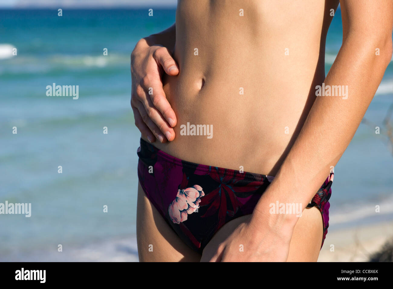 Woman in bikini bottom, mid section Stock Photo