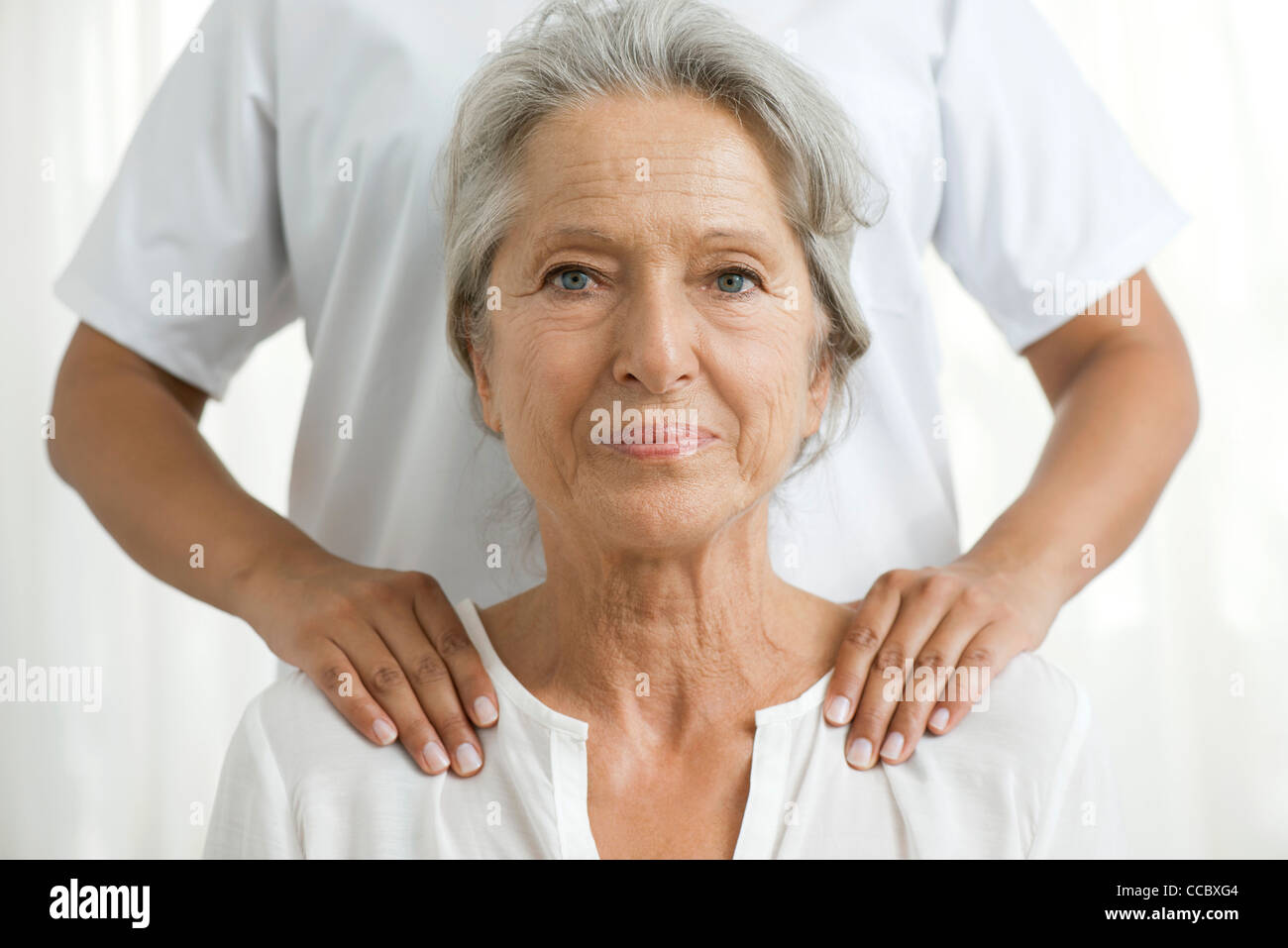 Senior woman getting a shoulder massage Stock Photo