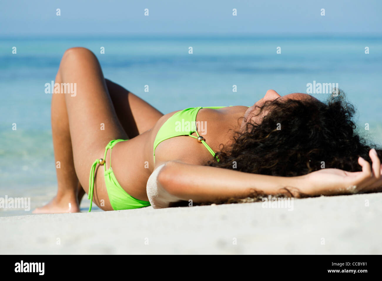 Woman in bikini sunbathing on beach Stock Photo pic photo